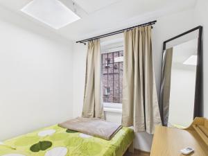 a bedroom with a bed and a window at Apartamenty Retro Loft in Chorzów