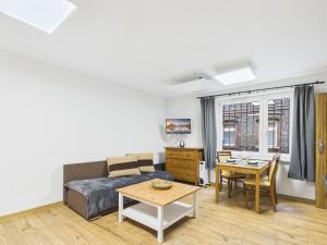 a living room with a couch and a table at Apartamenty Retro Loft in Chorzów