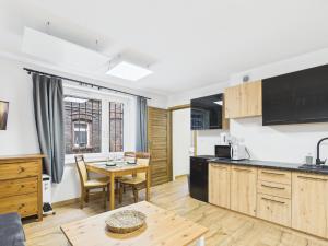 a kitchen and dining area with a table and chairs and a dining room at Apartamenty Retro Loft in Chorzów +24 photos