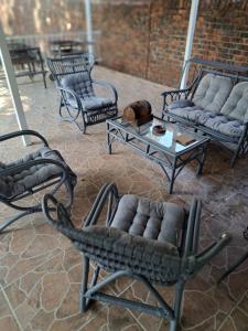 a group of chairs and tables on a patio at Siësta Guesthouse in Modimolle