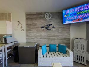 a room with a bench with blue pillows on it at Eden Dunes 75B in Shelly Beach