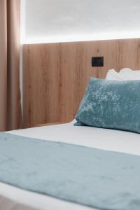 a bed with a blue pillow on top of it at Matteo Garden & Restaurant in Vlorë +44 photos
