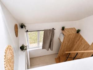 a tiny house with a staircase and a window at Petit Castel in Châteaubriant