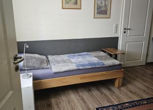 a bedroom with a bed with a blue mattress at Ferienwohnungen am Main in Erlabrunn