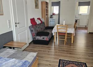 a living room with a couch and a table at Ferienwohnungen am Main in Erlabrunn