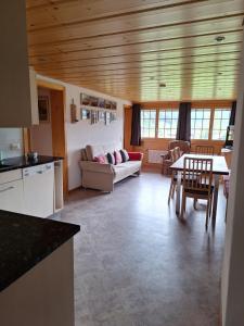 a kitchen and living room with a couch and a table at Mattihus in Sankt Stephan