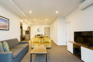 a living room with a couch and a tv at Quest East Perth in Perth +47 photos