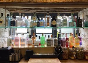 a shelf filled with lots of bottles of alcohol at The Bell Inn in Stroud