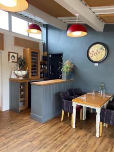 a dining room with a table and chairs at The Bell Inn in Stroud