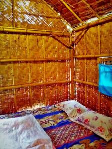 a bedroom with a bed in a bamboo wall at Baan Pai Likit in Pai