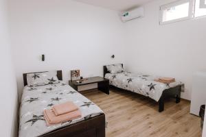 a bedroom with two beds and a window at Gallus Inn in Aleksinac +100 photos