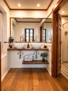 a bathroom with two sinks and a mirror at Palazzo Bolasco in Alghero +43 photos