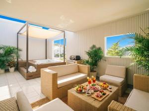 a living room with chairs and a table with fruit on it at Villa COLORS by Relapool in Inbu