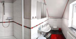 a bathroom with a sink and a toilet at Gästehaus AM HERMANN in Hörstel