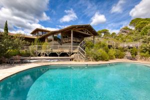 a house with a large pool in front of it at Villa dans Site Exceptionnel in Mourèze