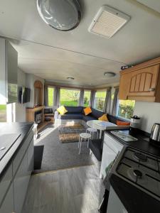a kitchen and living room of a caravan at Carn Kenidjack View Caravan, space, peace and tranquillity in Penzance