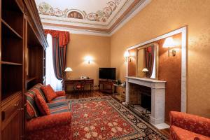 a living room with a couch and a fireplace at Phi Hotel Principe in Cuneo
