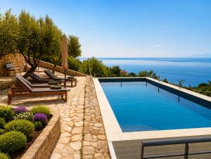 a swimming pool with a view of the ocean at Calypso Private Estate in Xiropigado