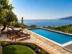 a swimming pool with a view of the ocean at Calypso Private Estate in Xiropigado