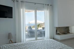a bedroom with a bed and a view of a bathroom at Chrysalis Nature Villa 9 in Kampos Paros +66 photos