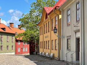 a row of buildings with chairs in a street at 5 person holiday home in ULRIKA in Rimforsa +47 photos