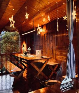 a dining room with a table in a cabin at Nirvana Trueliving in Nagar