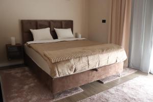 a bed with two pillows on it in a bedroom at Palas rooms in Smederevska Palanka