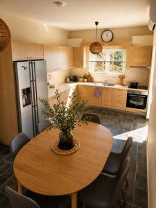 a kitchen with a wooden table and a refrigerator at Calypso Private Estate in Xiropigado
