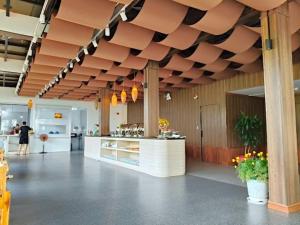 a large kitchen with a counter in a building at Golden Rose Hotel in Con Dao