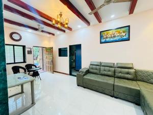 a living room with a couch and a table at Sukrut Villa, Alibag in Thāl