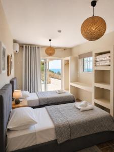 a hotel room with two beds and a window at Calypso Private Estate in Xiropigado +20 photos