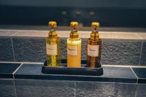 two bottles of essential oils sitting on a counter at Hotel Suite 2 in Warabi
