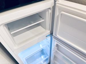 an empty refrigerator with its door open at Hotel Suite 2 in Warabi