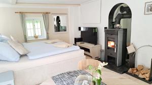 a bedroom with a bed and a wood stove at Ferienwohnung Urmannsau in Gaming