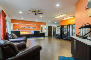 a living room with two leather chairs and a fireplace at Motel 6-Lincoln, NE in Lincoln