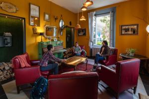 a group of people sitting in a waiting room at Wild Valley Hostel - Villa Edera in Auressio