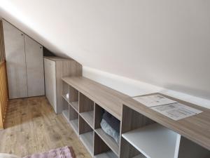 a room with a staircase with wooden shelves at Trésor de Beaurains in Beaurains +25 photos