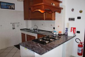 a kitchen with a stove and a counter top at Sweet House in Agerola