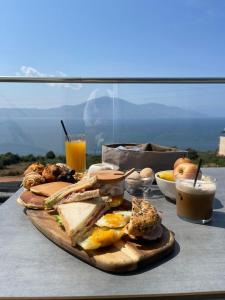 a plate of food on a table with breakfast foods at Hotel Majestic in Vlorë