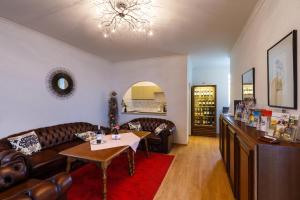 a living room with a couch and a table at Weingut Franz Schindler in Mörbisch am See +29 photos