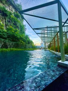 a river with a bridge over the water at The Cove Hillside@Loft in Ipoh