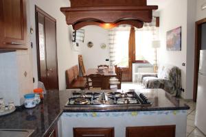 a kitchen with a stove top oven in a room at Sweet House in Agerola
