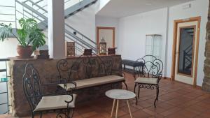 a porch with chairs and a bench and a table at Ruralis Las Nogalas in Montánchez +50 photos