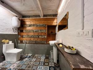 a bathroom with two toilets and a sink at Nirvana Trueliving in Nagar