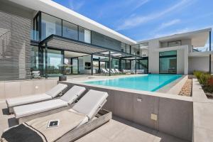an exterior view of a house with a swimming pool at La Villa at Pezula in Knysna