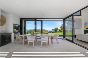 a dining room with a table and chairs at La Villa at Pezula in Knysna