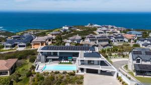 an aerial view of a house with a swimming pool at La Villa at Pezula in Knysna