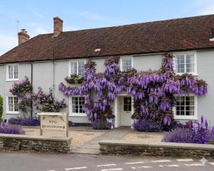 a white house with purple flowers on it at Meryan House Hotel in Taunton