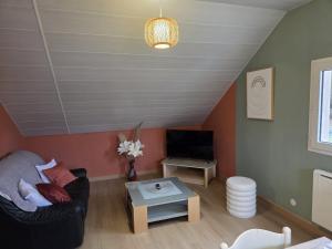 a living room with a couch and a table at au pont vieux in Chanac
