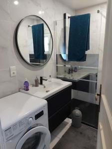 a bathroom with a washing machine and a mirror at au pont vieux in Chanac +26 photos
